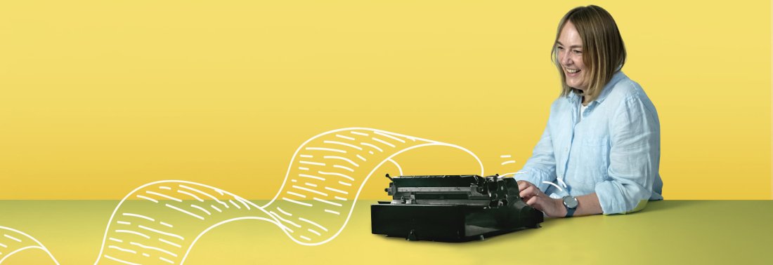 A woman using a typewriter in front of a yellow background