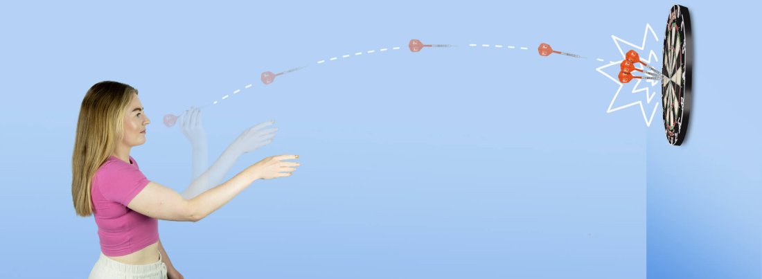 A woman throwing a dart in front of a blue background